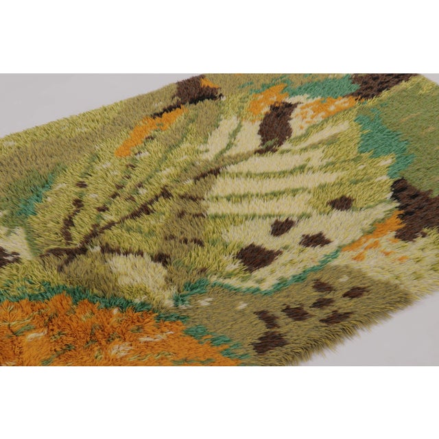 Hand-knotted in lush, high-pile wool in Sweden circa 1960-1970, this 5x7 vintage Swedish Rya rug is a bold new addition to...