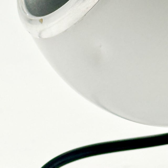 A 1970s Italian Space Age table lamp by Targetti Sankey, featuring the iconic “eyeball” form with a fully adjustable...