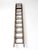 Early 20th century Oshkosh Patented Safety Ladder featuring weathered wood rails, iron hardware, and original pulley...