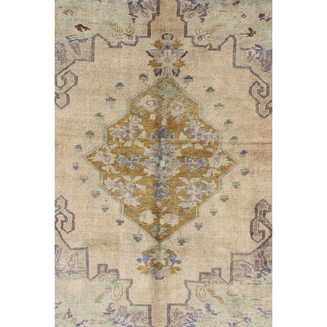 This soft and cheerful Oushak carpet proudly displays a unique color combination in any carpet. On the center of this rug...