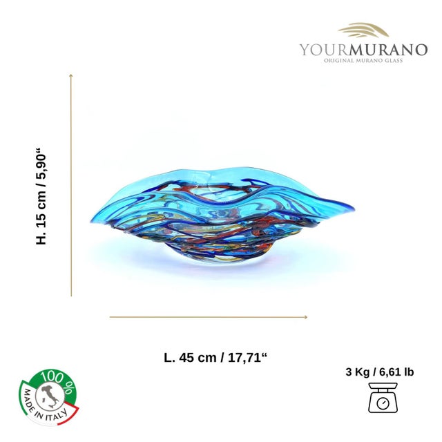 Centerpiece in light blue Murano glass, embellished with multicolored filaments that give a touch of freshness and...