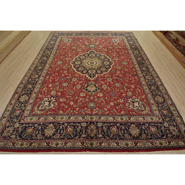 An authentic vintage traditional Tabriz rug hand-knotted with fine wool and natural dyes. This rug features a central...