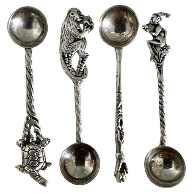 A wonderful set of four sterling silver spoons, each with a different handle, Elf, Monkey, closed fist, turtle -...