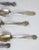 Collection of 9 mismatched novelty souvenir teaspoons. 8 are marked sterling (5 oz.) 1 is silverplate. Various makers, 2...