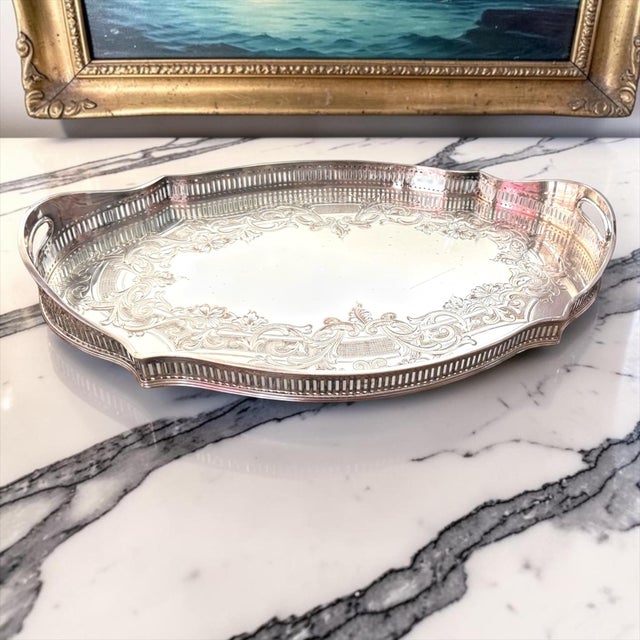 An elegant antique Sheffield silverplate gallery tray dating to the mid 20th century, featuring beautifully engraved...