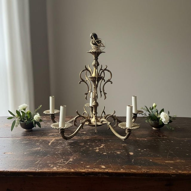 Vintage 5-light chandelier with dramatic Hollywood Regency and Spanish Revival styling, likely made in the United States...