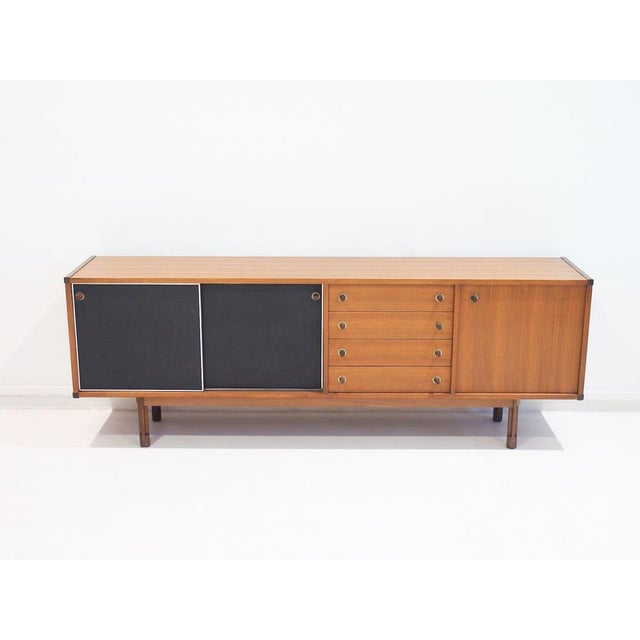 Teak sideboard from the '60s designed by George Coslin. Front with two black leatherette covered sliding doors, four...