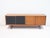Teak sideboard from the '60s designed by George Coslin. Front with two black leatherette covered sliding doors, four...