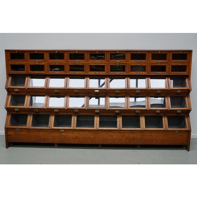 This shop cabinet was produced during the 1920/30s in the Netherlands. This piece features 26 compartments with drop down...