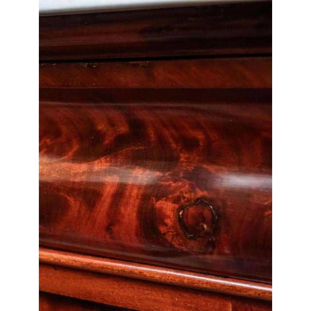 Restored folding secretary from the Biedermeier period with beautiful folded mahogany, which forms regular stripes and...