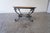 Beautiful 1950s Moroccan coffee table featuring a large hand-worked copper tray top set on an elegant wrought iron base....