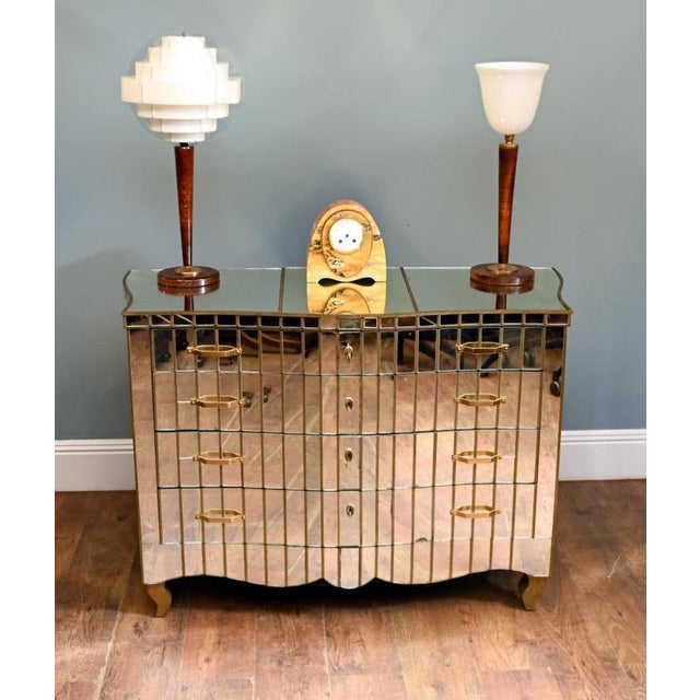 A stylish Art Deco mirrored chest of drawers dating to the 1930s, featuring a gently serpentine front and entirely clad in...