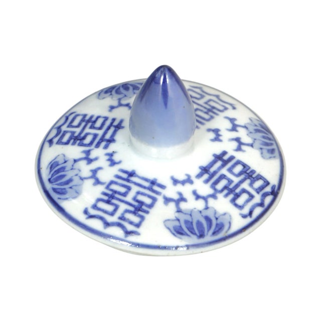 A traditional Chinese ceramic temple jar with lidded top. Decorated with hand painted blue floral patterns over a white...