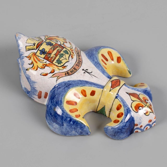 A 19th century French faience fleur-de-lis wall pocket, commonly used as a wall vase for flowers or as a decorative item....