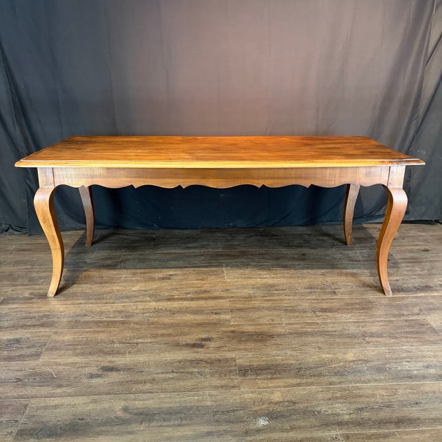 Handsome 19th century French Louis XV walnut table with a broad rectangular plank top above a gracefully scalloped apron...