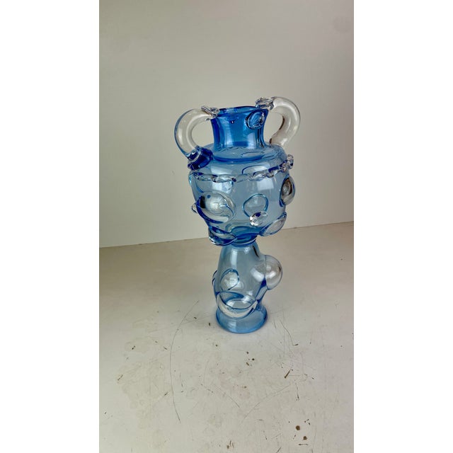 Magnificent and huge vase made of shades of blue glass, a gradient from clear to soft with bubbles and exaggerated shapes....