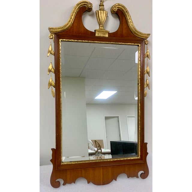 Add a touch of timeless elegance to your home with this stunning Chippendale-style wall mirror. Featuring a rich mahogany...