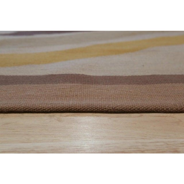 This 6 x 8 area rug is a flat weave Kilim crafted entirely from wool. The primary color palette features a neutral blend...