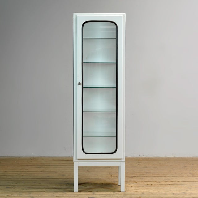 Vintage medical cabinet from the 1970s, made in Hungary. This characterful cabinet is made of iron and glass, with the...