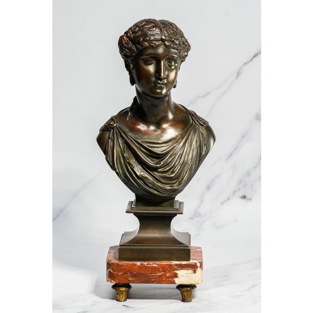 A refined expression of nineteenth-century French bronze artistry, this elegant patinated bronze bust depicts Venus, the...