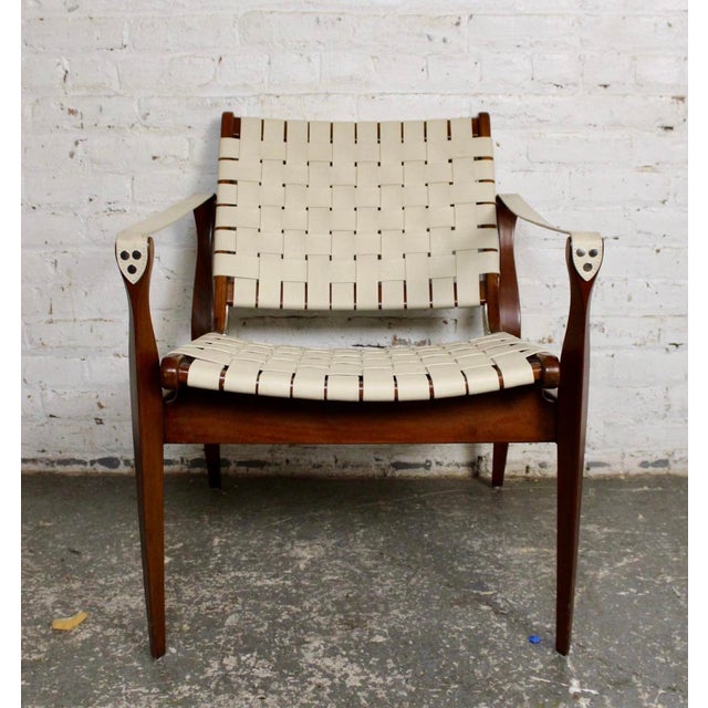 This stunning safari chair is supported by a rich mahogany frame and made up of beautifully woven cream leather. It's...