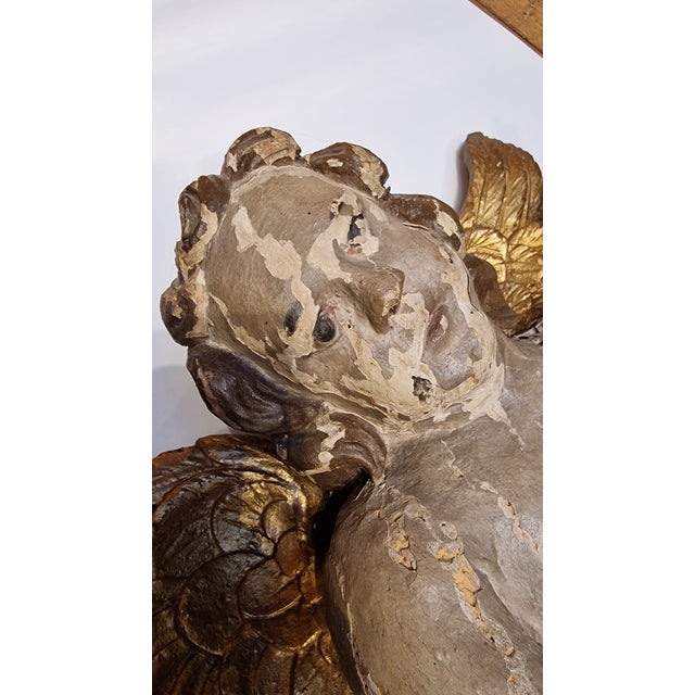 Cherub carved in wood, polychrome and gilded with leaf.