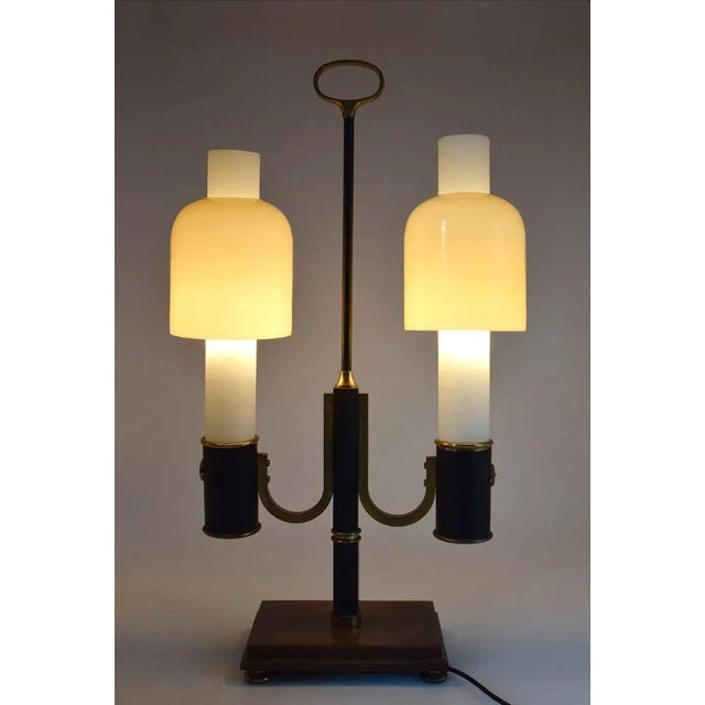 Ministerial table lamp, made in Italy in the 1950s. Wooden base with brass feet, structure in painted metal and brass with...