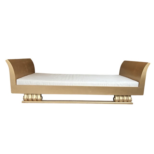 Unique dramatic piece. Gold wood Egyptian style daybed. Newly reupholstered cushion in natural canvas fabric.