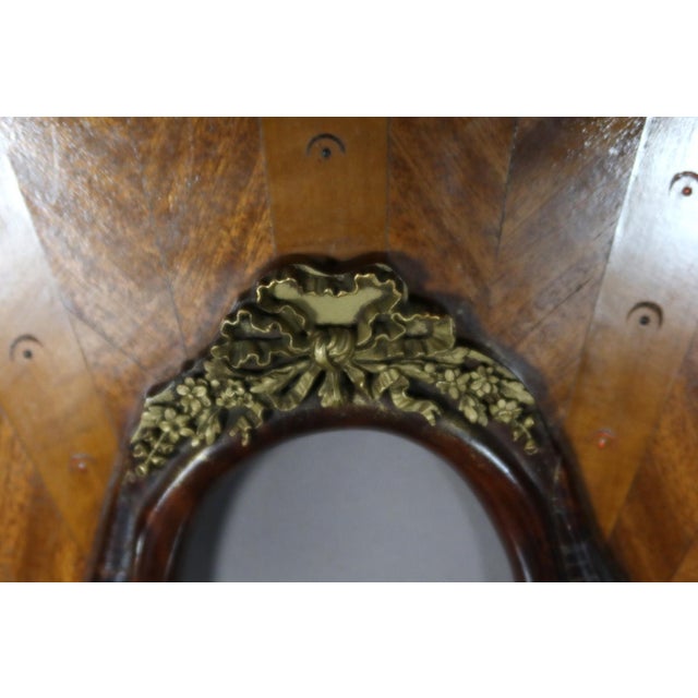 Pair of Large 19th Century Picture Frames. Pair of large oval marquetry frames adorned with gilt bronze mounts. These...