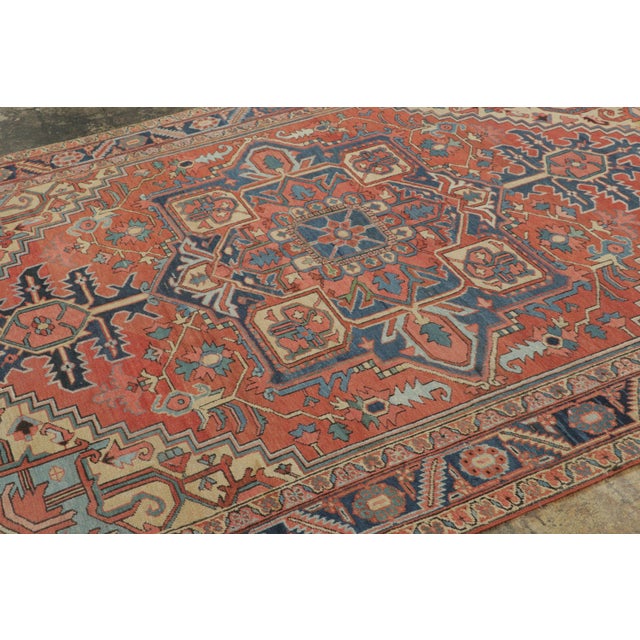 This antique 7x10 Persian Heriz rug originates from Persia circa 1920-1930. Hand-knotted in wool, it features sharp tribal...
