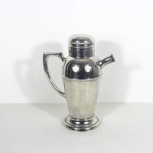 Fabulous silverplated art deco cocktail shaker. This is a large cocktail shaker with a handle, lid, strainer inside and...