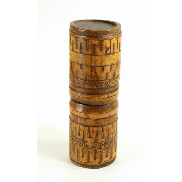 A fine old ethnographic relic from Indonesia It is a cylindrical lime container made of carved wood, most likely bamboo...