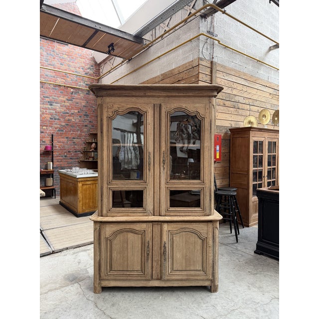 This very old two-section sideboard made of solid oak has been completely restored. It consists of an upper section with...