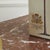 Square ceramic box in cream with detailed palm illustrations and a royal coat of arms on all four sides. The decoration is...