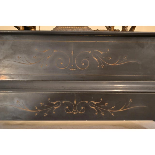 Japy & Freres, circa 1870s Figural French clock; two figures depicting women holding spear and fish and man with feathered...