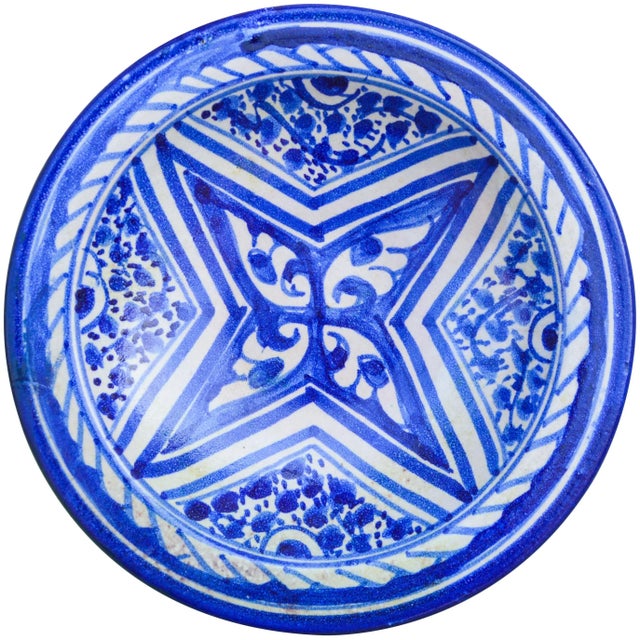 Handcrafted and glazed ceramic plate with an elaborate hand-painted Moorish pattern in blue and white. Made in Fez,...
