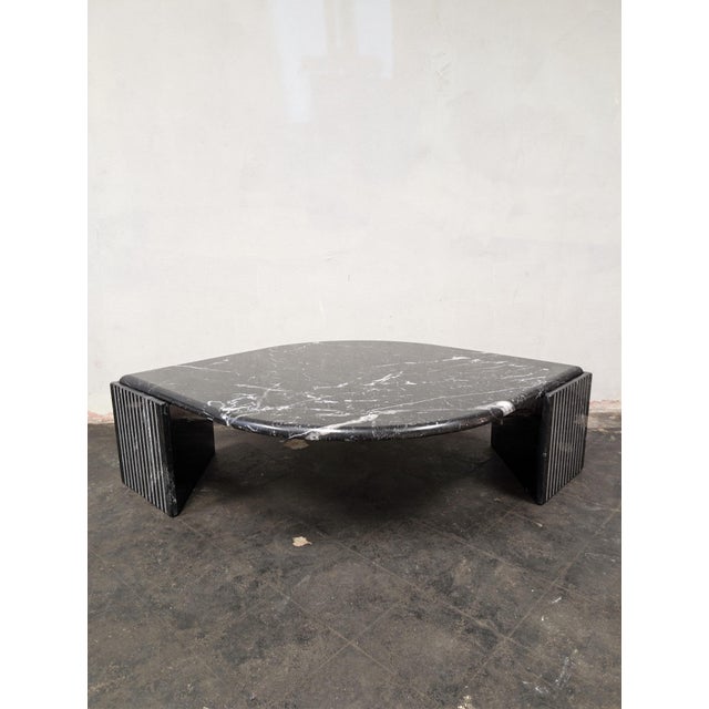 Designed and made in Italy in the 1980s, this teardrop or eye shaped coffee table sits on two fluted triangular pedestals...