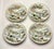 Four hand‑painted Japanese Kutani saucers, each featuring a scenic landscape with birds, blossoms, and soft mountain...