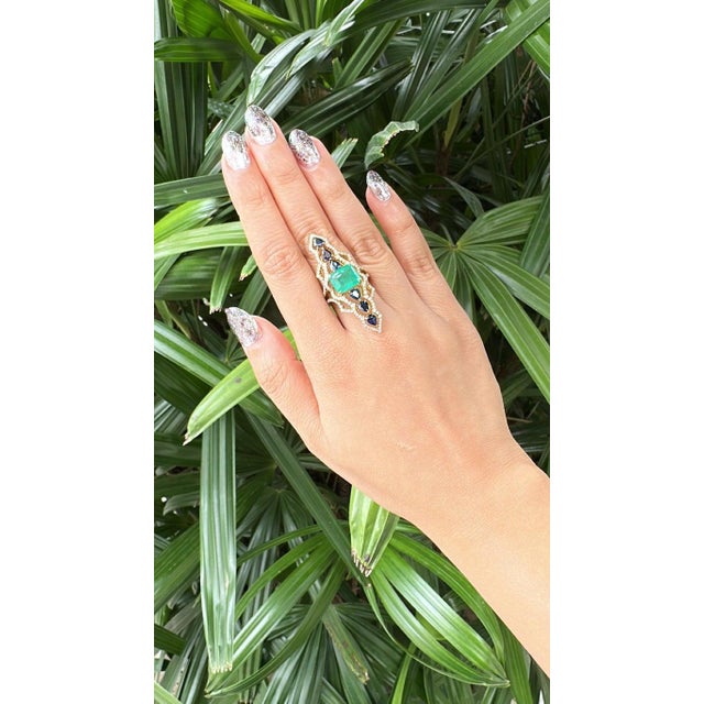 A very gorgeous and beautiful, modern style, Emerald & Blue Sapphires Cocktail Ring set in 18K Yellow Gold & natural...