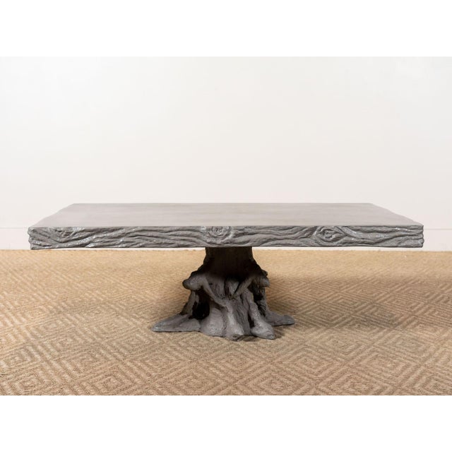 Handmade cocktail table Crafted from reinforced concrete in Waxed Gray Branch-like base and polished top Suitable for...