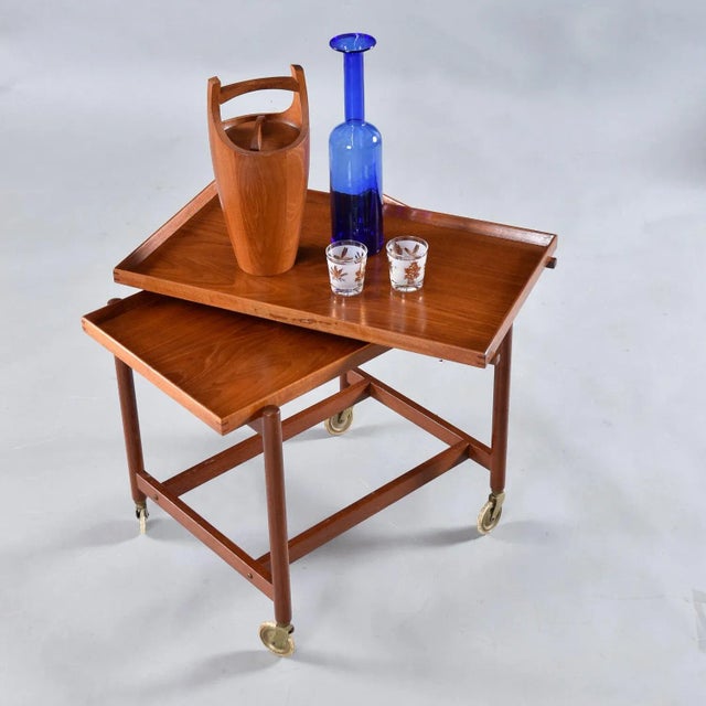 Dynamic, versatile, "the life of the party," we're not talking about you. Or are we? This Poul Hundevad Danish teak...