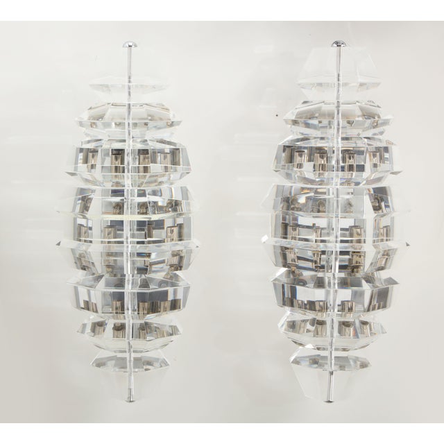 Spectacular giant pair of faceted Lucite sconces. The sconces are beautifully executed and have been newly rewired with...