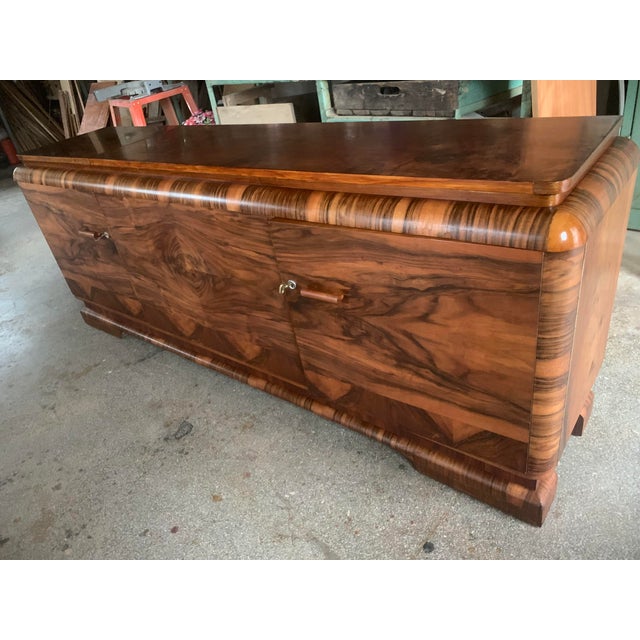 Art Deco chest of drawers, 1920s, long and low. A practical piece of furniture with wooden shelves behind the doors. The...
