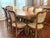 This spectacular Italian Provincial Baroque-style marquetry dining room table and 8 matching chairs will elevate any...
