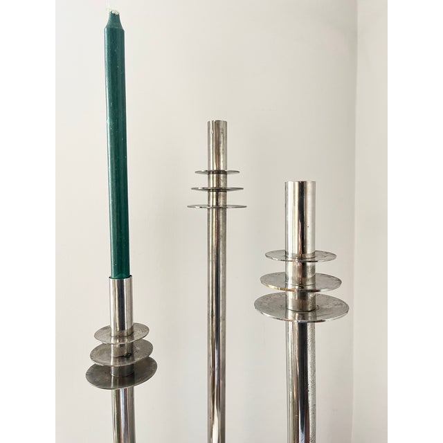 A striking set of vintage chrome-plated candlesticks inspired by elegant Art Deco design and 20th-century modernist...