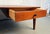 Elegant mid-century modern coffee table crafted from warm, richly grained walnut. Features clean lines, tapered legs, and...