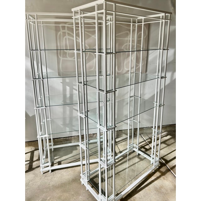 Elevate your space with this rare pair of 1980s Postmodern etageres. Attributed to Mirak. Featuring a unique tri-pole...