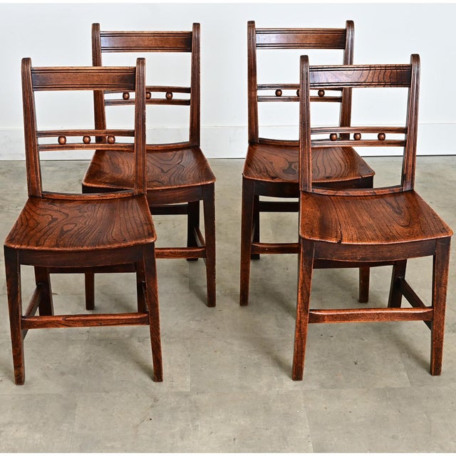 English set of four oak dining chairs in the late Georgian style (late 18th century), handcrafted from oak with tactile...