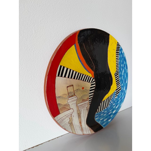 Exceptional hand-painted ceramic decorative plate by Lois Barton, created in the 1980s. This striking Modernist...