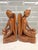 An extraordinary, investment-grade pair of matching mid-century Balinese Art Deco bookends depicting seated maidens...
